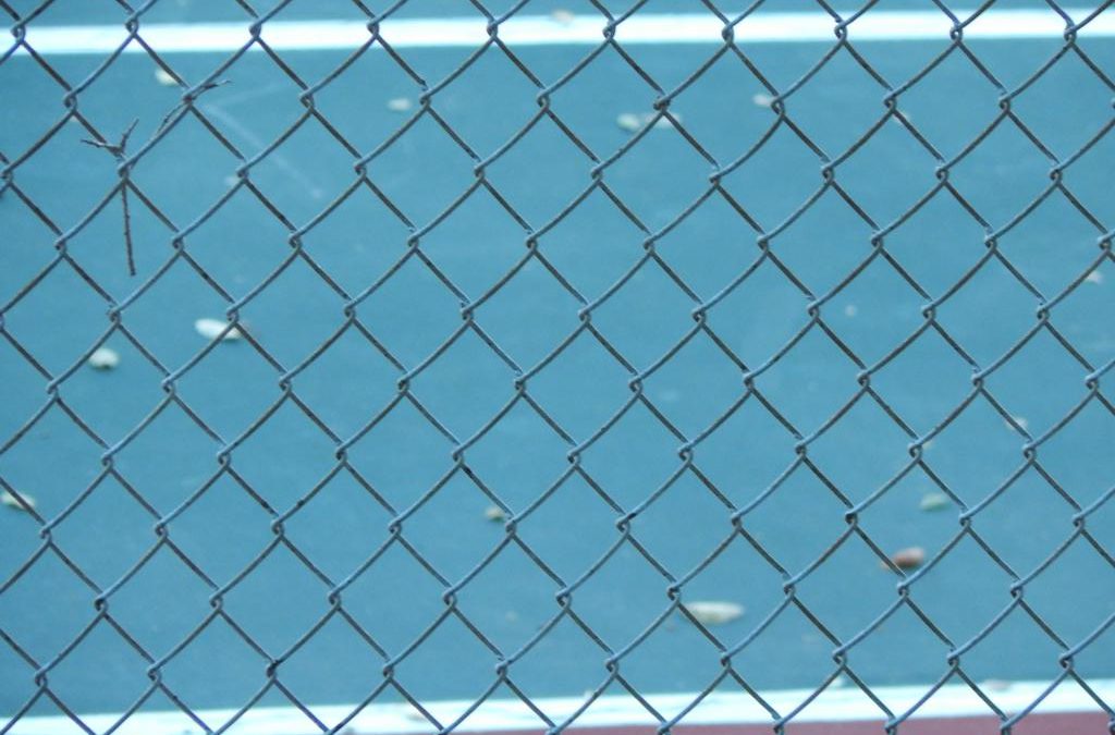 tennis court through fence